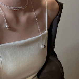 Elegant minimalist silver layered long necklace with polished metal spheres for women
