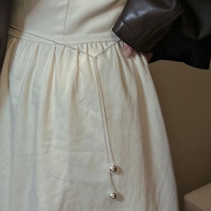 Minimalist silver chain waist belt with dual smooth metal ball charms on leather outfit