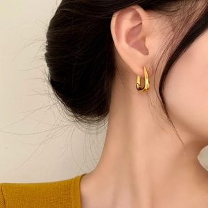 Elegant gold U-shaped square hoop earrings shown on a model for a minimalist daily look