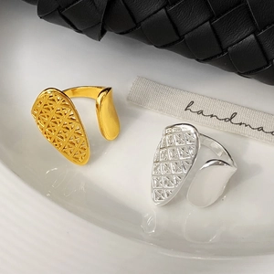 Minimalist asymmetric open mesh rings in gold and silver finish with teardrop pattern