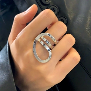 Modern silver irregular hollow wrap ring with minimalist geometric aesthetic on finger