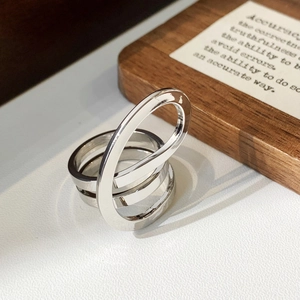 Detailed view of silver intertwined multi-layer ring with minimalist oval architectural design