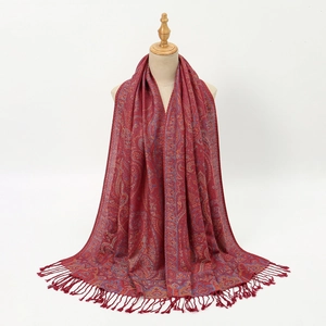 Close-up of burgundy Paisley jacquard pattern with fine tassel fringe on long shawl
