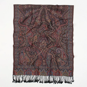 Close-up of elegant burgundy paisley shawl with intricate floral patterns and black fringe