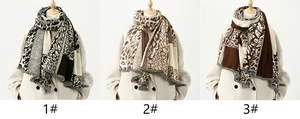 Three leopard print scarves in different colors with soft fringes and cashmere texture