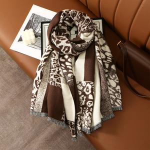 Macro view of leopard print cashmere feel scarf with soft fringe details and thick texture