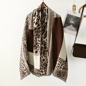 Detail of leopard print cashmere scarf with geometric blocks and fringed edges