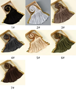 Detail view of cotton hijabs with gold sequin trim in seven elegant solid colors