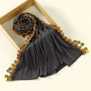 Detail of dark grey mercerized cotton hijab with gold wave embroidery and sequins