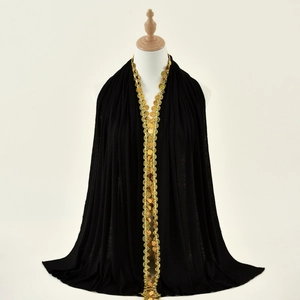 Detail of black mercerized cotton scarf with gold sequin coin lace and elegant drape