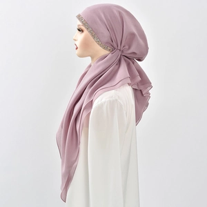 Detail of dusty pink hijab featuring elegant colorful rhinestones on a chiffon fabric