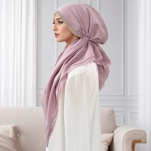 Close-up of lotus pink Muslim hijab featuring detailed gold and silver sequin embroidery