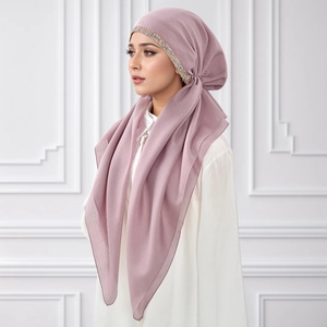 Detail of dusty pink hijab with decorative rhinestone trim and elegant fabric draping