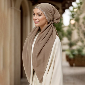 Detail of coffee brown hijab featuring elegant silver beaded rhinestone trim accents
