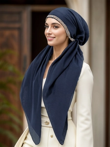 Close-up of navy blue ethnic hijab with silver hand-beaded edge and chiffon layering