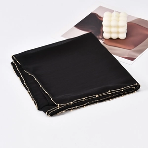 Black chiffon hijab scarf featuring elegant gold beaded edges shown on a white background