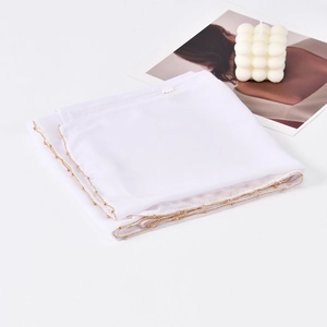 Elegant white chiffon scarf with golden chain trim displayed against a minimalist background