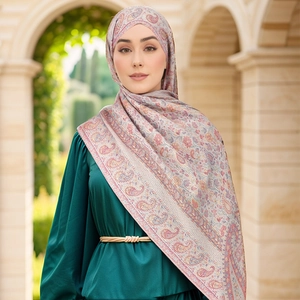 Close-up of paisley print hijab scarf paired with a satin dress and gold braided belt