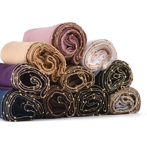 Multicolor chiffon headscarf with gold bead trim detail in a stacked arrangement