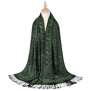 Ethnic paisley tassel scarf in dark green and gold brocade texture on mannequin