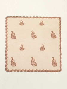 Detail of beige square scarf featuring brown paisley embroidery and intricate lace edges