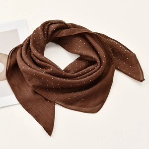 Detail of dark brown silk headscarf with shimmering rhinestones and soft chiffon texture