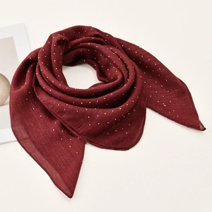 Close-up of wine red silk scarf with sparkling rhinestones and shimmering texture