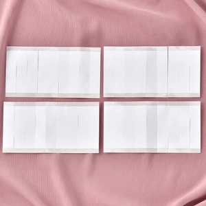Strong adhesive non-slip tapes for hijabs and scarves shown on pink fabric texture