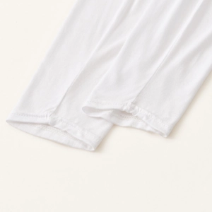 Close-up of white mercerized cotton shoulder sleeves showing double-needle hemmed cuffs