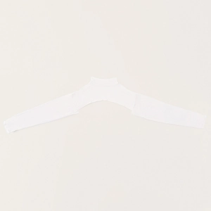 Detail of white mercerized cotton turtleneck shrug showing the elastic breathable knit fabric