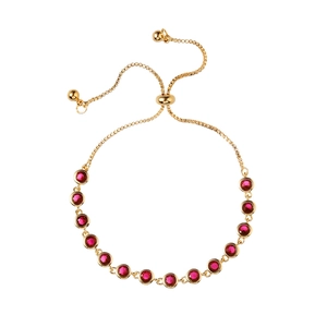 Adjustable gold bolo bracelet with thirteen round ruby-red gemstones on a white background