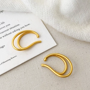 Minimalist double-layered matte gold ear cuffs in a stacked design for a modern look
