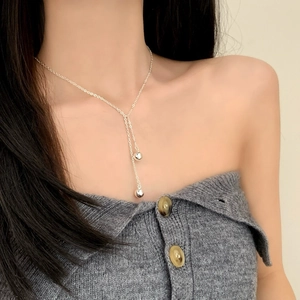 Elegant silver Y-shaped tassel necklace with minimalist metallic sphere beads for women