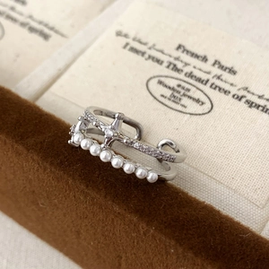Elegant double layer ring with sparkling star charm and white pearls on velvet stand