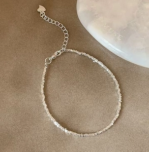 Close-up of S925 sterling silver heart pendant and irregular faceted bead bracelet