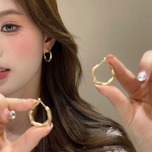 Minimalist matte gold twisted hoop earrings with elegant irregular pleated design for women