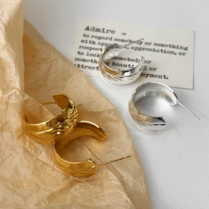 Chic gold and silver C-shaped hoop earrings with textured wave finish for women