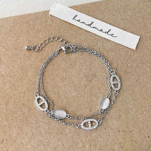 Double-layered silver bracelet with white opal stone and pavé anchor link charm