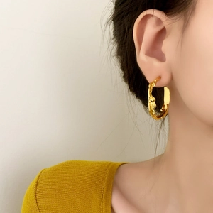 Minimalist irregular gold stud earrings with molten texture and metallic mirror finish