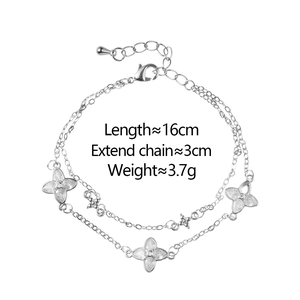 Detail view of double-layer clover bracelet with silver finish and sparkling zircon stones