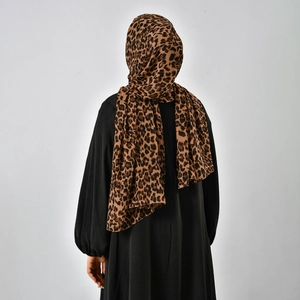 Rear view of a premium leopard print chiffon headscarf paired with a black long-sleeved abaya