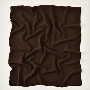 Detail of dark brown chiffon scarf featuring delicate golden metallic stitched edges