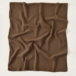 Detail of dark brown pearl chiffon scarf with fine gold chain edge and soft drape