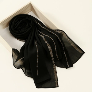 Detail of black chiffon hijab scarf with elegant hot-fix rhinestones in geometric patterns