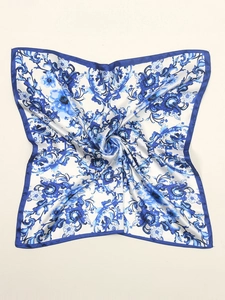 Detailed macro view of floral pattern and smooth satin texture on the square silk scarf