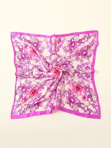 Detailed close-up of pink floral silk scarf with baroque patterns and purple border