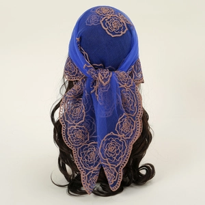 Détail d'un foulard en dentelle bleu foncé avec broderie rose brune et bords festonnés