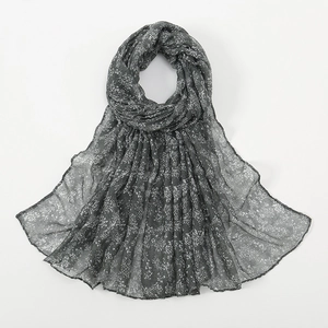 Detail of sheer dark grey scarf with white floral print and premium hemmed edges
