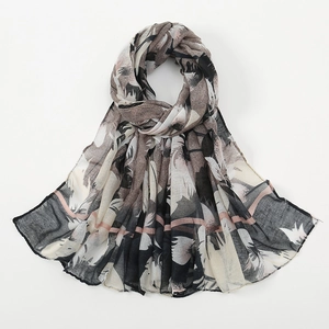 Close-up of lightweight floral voile scarf with black and beige abstract prints