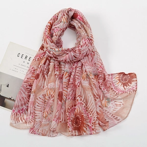 Detail view of voile floral scarf with pink and orange abstract textures and magazine props